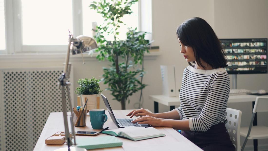 A woman working at a desk in a bright office