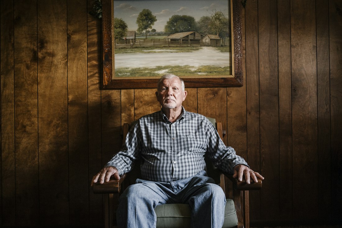 An older man sitting in an armchair in his living room